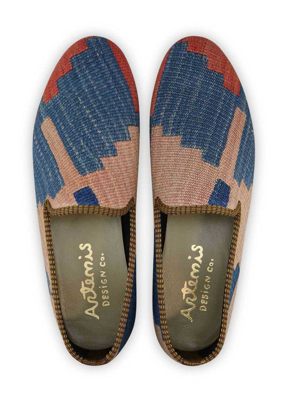 The Artemis Men's Loafers epitomize elegance with a striking mix of blue, royal blue, beige, and red. These loafers seamlessly blend the serene shades of blue and royal blue, accentuated by touches of warm beige and bold flashes of red. The result is a harmonious interplay of colors that radiate confidence and sophistication. (Front View)