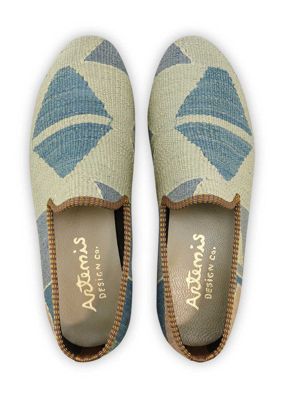 Artemis Design & Co Men's Loafers offer a classic and timeless footwear option with a color combination of blue, white, grey, and brown. These loafers are meticulously crafted, often featuring handwoven kilim textiles in these sophisticated and versatile shades.  (Front View)