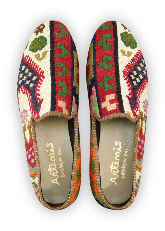 Artemis Design Co. Mens Loafers offer a vibrant fusion of colors, blending shades of red, green, peach, navy blue, orange, white, and brown. These stylish loafers boast a unique and eye-catching design, perfect for individuals seeking to make a bold fashion statement. Crafted with meticulous attention to detail, they marry elegance with personality, ensuring both comfort and flair with every step. (Front View)