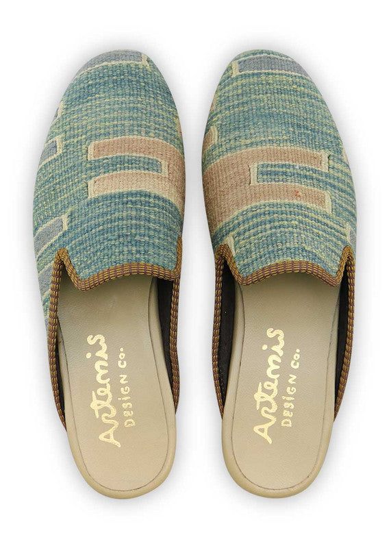 Artemis Design & Co introduces Men's Slippers in a serene color palette, featuring shades of teal, blue, and light blue. Elevate your downtime with these thoughtfully crafted slippers, where cool tones meet minimalist design. The harmonious blend of tranquil hues adds a touch of sophistication, making these slippers a stylish choice for the modern man. (Front View)