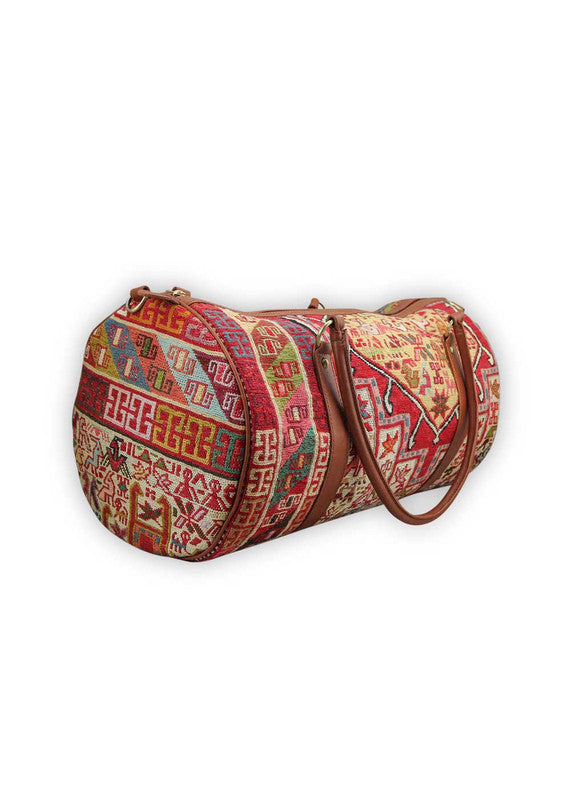 The Artemis Design & Co Travel Duffle Bag is a vibrant travel essential, boasting a lively color combination of red, white, blue, cream, orange, green, and maroon. Meticulously crafted, this duffle bag seamlessly blends patriotic and earthy tones, creating a dynamic and stylish companion for your journeys. The interplay of colors, from the patriotic red, white, and blue to the warm cream, energetic orange, lush green, and rich maroon, adds a playful and modern flair. (Side View)