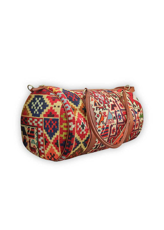 The Artemis Design & Co Travel Duffle Bag is a vibrant travel essential, boasting a lively color combination of red, white, blue, cream, orange, green, and maroon. Meticulously crafted, this duffle bag seamlessly blends patriotic and earthy tones, creating a dynamic and stylish companion for your journeys. The interplay of colors, from the patriotic red, white, and blue to the warm cream, energetic orange, lush green, and rich maroon, adds a playful and modern flair. (Side View)