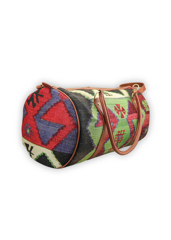 The Artemis Design & Co Travel Duffle Bag is a sleek and stylish travel companion with a patriotic color palette of red, white, blue, black, green, and maroon. Meticulously crafted, this duffle bag seamlessly blends bold and classic tones, creating a versatile accessory for your journeys. The dynamic interplay of colors, from the patriotic red, white, and blue to the timeless black and lush green, accented by the rich maroon, adds a touch of modern flair. (Side View)