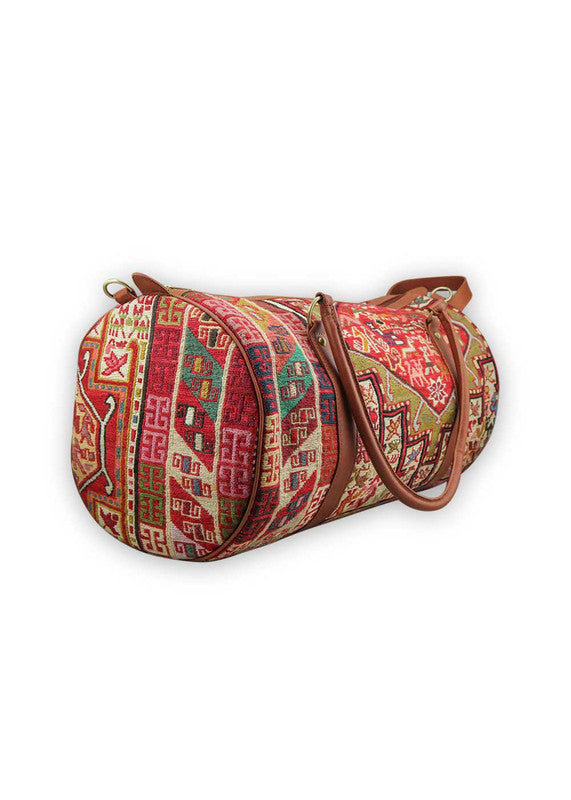 The Artemis Design & Co Travel Duffle Bag is a vibrant travel essential, boasting a lively color combination of red, white, blue, cream, orange, green, and maroon. Meticulously crafted, this duffle bag seamlessly blends patriotic and earthy tones, creating a dynamic and stylish companion for your journeys. The interplay of colors, from the patriotic red, white, and blue to the warm cream, energetic orange, lush green, and rich maroon, adds a playful and modern flair. (Side View)