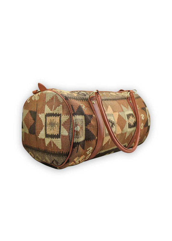 The Artemis Design & Co Travel Duffle Bag exudes timeless elegance with a sophisticated color palette of peach, brown, khaki, cream, and grey. Meticulously crafted, this duffle bag seamlessly blends warm and neutral tones, offering a chic and versatile travel companion. The interplay of colors, from the soft peach and khaki to the rich browns and creams, harmonized by the subtle greys, adds a touch of modern flair. (Side View)