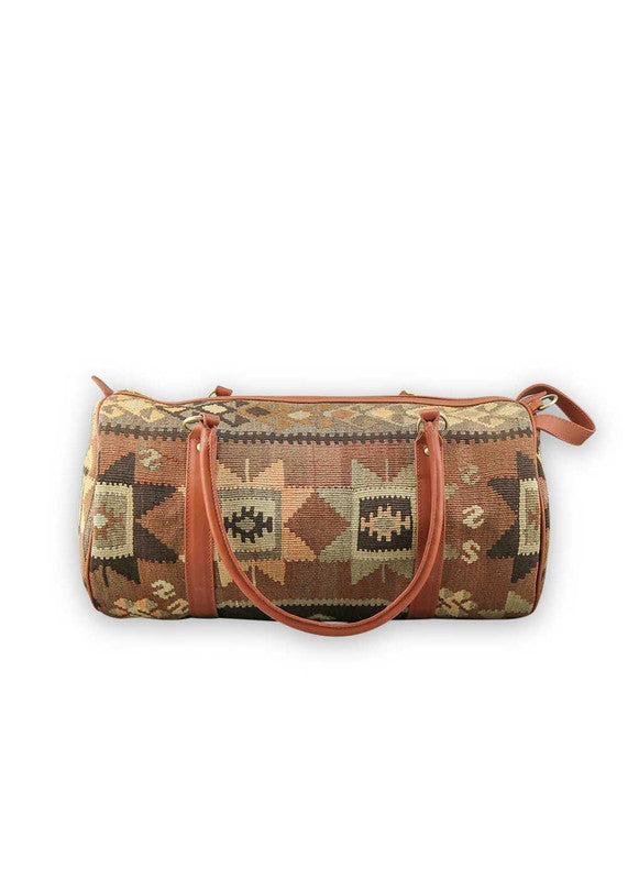 The Artemis Design & Co Travel Duffle Bag exudes timeless elegance with a sophisticated color palette of peach, brown, khaki, cream, and grey. Meticulously crafted, this duffle bag seamlessly blends warm and neutral tones, offering a chic and versatile travel companion. The interplay of colors, from the soft peach and khaki to the rich browns and creams, harmonized by the subtle greys, adds a touch of modern flair. (Front View)