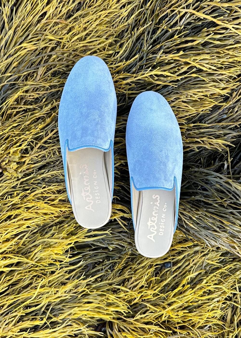 the Suede Slippers in blue from Artemis Design & Co are a must-have for those seeking both comfort and style. Crafted with high-quality suede, these slippers offer a plush and cozy feel for your feet. 