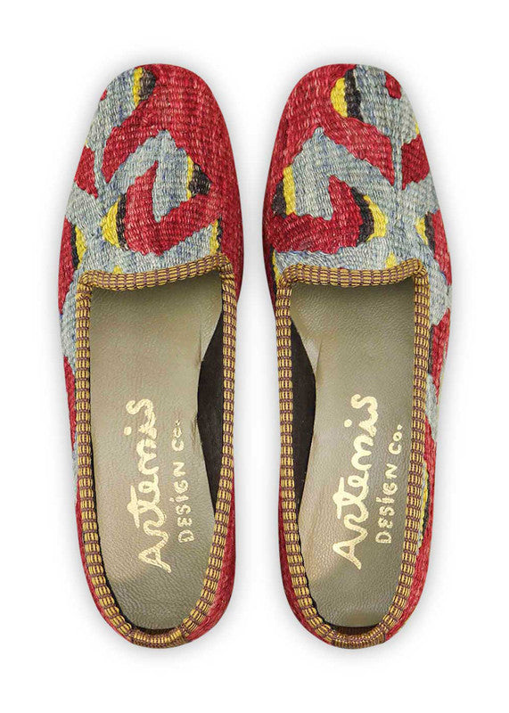 Artemis Design & Co Women's Loafers make a bold statement with a captivating color palette of maroon, blue, black, and yellow. Meticulously crafted, these loafers seamlessly blend rich and vibrant tones, creating a stylish and eye-catching footwear option. (Front View)