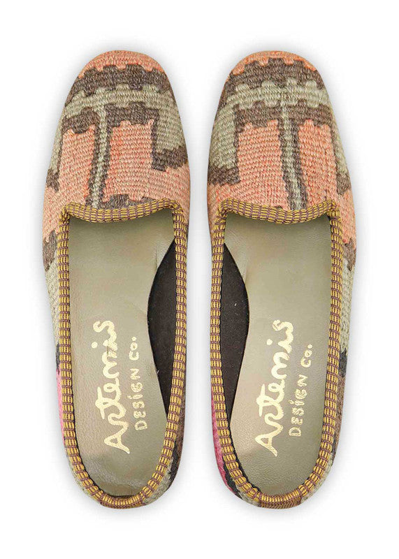 Artemis Design & Co Women's Loafers redefine classic charm with a refined color palette of peach, brown, grey, khaki, and black. Meticulously crafted, these loafers seamlessly blend warm and neutral tones, creating a versatile and stylish footwear option. (Front View)