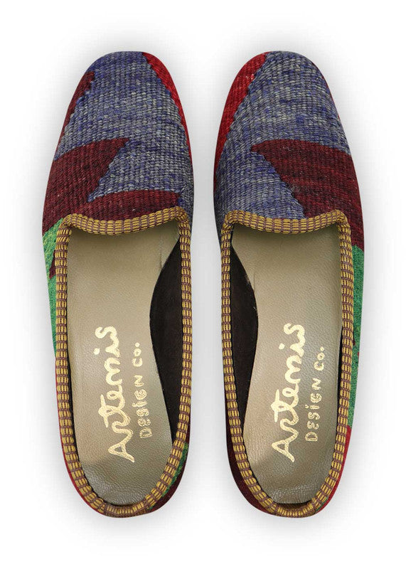 Artemis Design Co. Women's Loafers captivate with a vibrant and stylish color combination of red, blue, green, and purple. Meticulously crafted, these loafers seamlessly blend energetic and bold tones, creating a versatile and eye-catching footwear option. The dynamic interplay of colors, from the bold reds and blues to the lively greens and rich purples, adds a touch of modern flair. ( Front View)