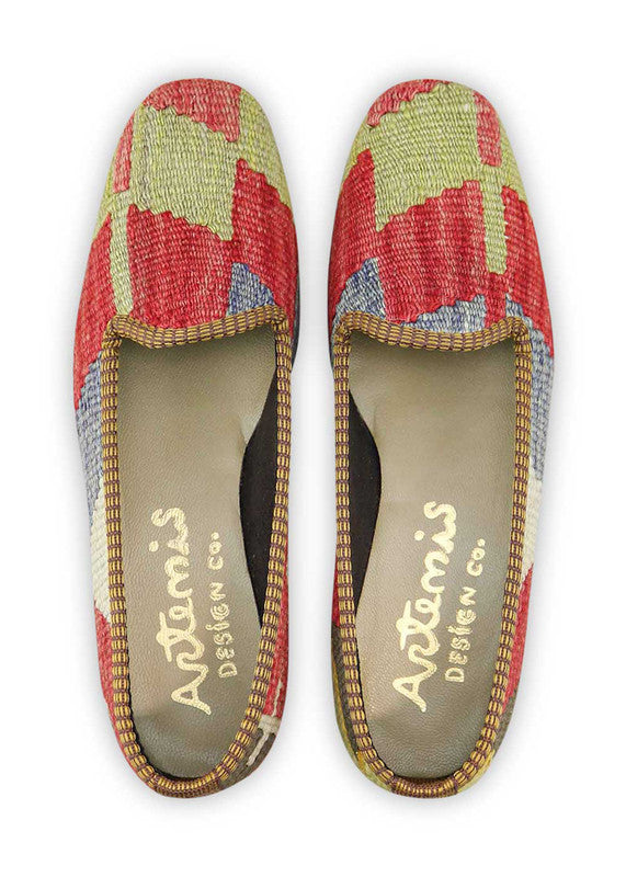Artemis Design & Co Women's Loafers make a vibrant statement with a dynamic color palette of red, blue, green, white, black, and yellow. These meticulously crafted loafers seamlessly blend bold and neutral tones, creating a stylish footwear option for any occasion. (Front View)
