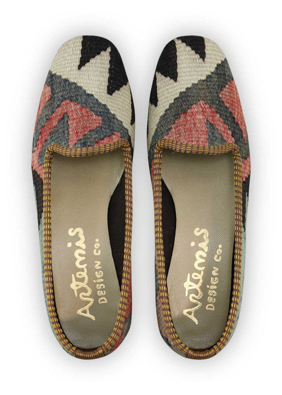 Artemis Design Co. Women's Loafers showcase a bold and classic color palette of blue, black, white, red, and grey. Meticulously crafted, these loafers seamlessly blend timeless and vibrant tones, creating a versatile and stylish footwear option. The dynamic interplay of colors, from the serene blues and crisp whites to the bold reds, classic black, and subtle greys, adds a touch of modern flair. (Front View)