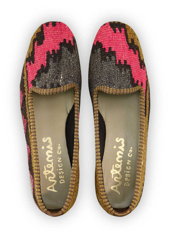 Artemis Design Co. Women's Loafers radiate bold sophistication with a captivating color palette of fuchsia, dark grey, black, brown, and violet. Meticulously crafted, these loafers seamlessly blend vibrant and neutral tones, creating a versatile and stylish footwear option. The dynamic interplay of colors, from the striking fuchsia to the classic black and brown, accented by the deep dark grey and rich violet, adds a touch of modern flair. (Front View)
