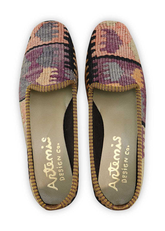 Artemis Design Co. Women's Loafers radiate sophistication with a refined color palette of black, white, violet, peach, and grey. Meticulously crafted, these loafers seamlessly blend classic and muted tones, creating a versatile and stylish footwear option. The dynamic interplay of colors, from the timeless black and white to the subdued violets, warm peach, and subtle greys, adds a touch of modern flair. (Front View)