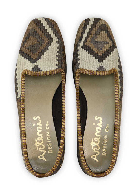 Artemis Design Co. Women's Loafers epitomize timeless elegance with a classic color palette of black, brown, white, and grey. Meticulously crafted, these loafers seamlessly blend neutral and muted tones, creating a versatile and stylish footwear option. The dynamic interplay of colors, from the classic black and white to the rich browns and subtle greys, adds a touch of modern flair. (Front View)