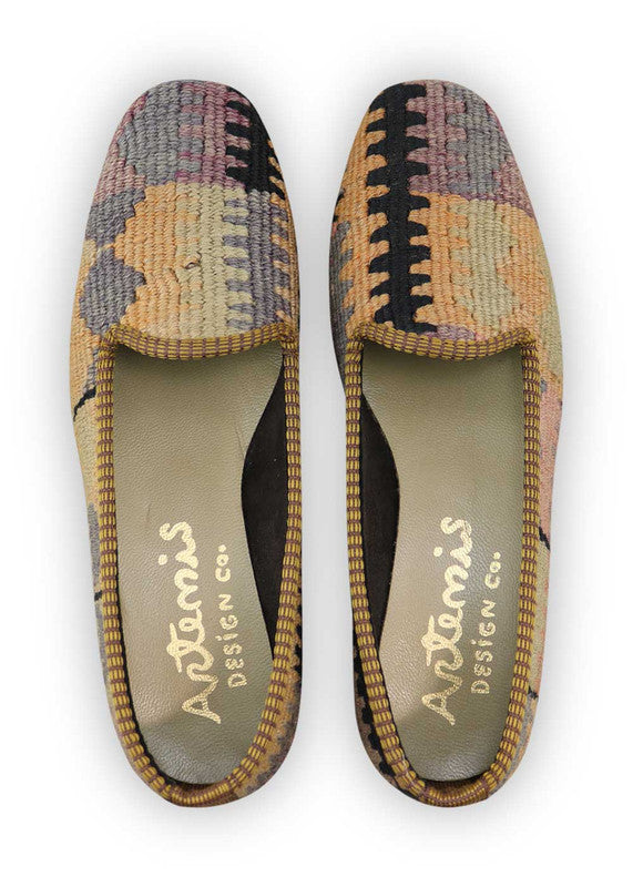 Artemis Design Co. Women's Loafers showcase a chic and vibrant color palette, featuring black, grey, peach, pink, orange, and lilac. Meticulously crafted, these loafers seamlessly blend neutral and bold tones, creating a versatile and stylish footwear option. The dynamic interplay of colors, from the classic black and grey to the warm peach, playful pink, vibrant orange, and soft lilac, adds a touch of modern flair. (Front View)
