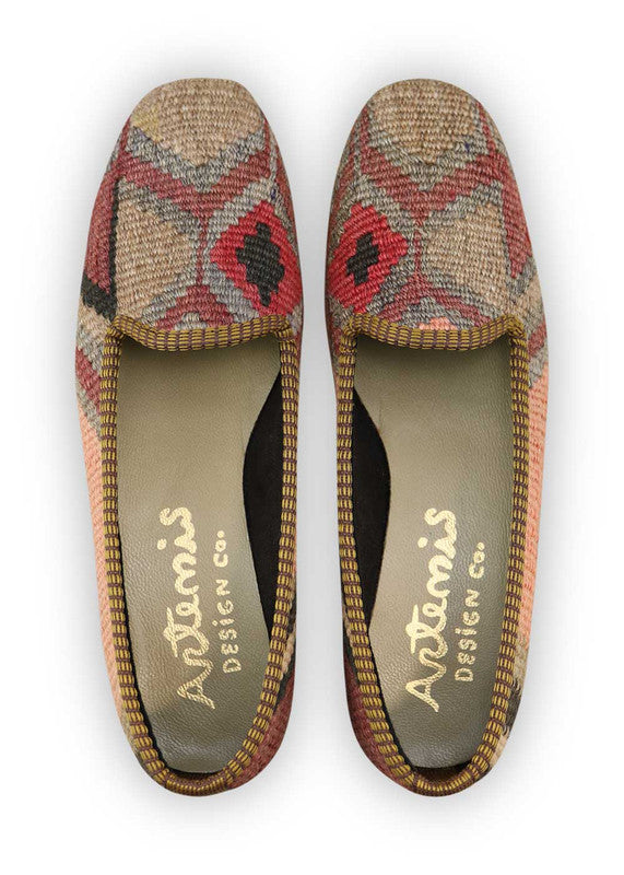Artemis Design Co. Women's Loafers embody chic versatility with a sophisticated color palette of peach, black, grey, red, and khaki. Meticulously crafted, these loafers seamlessly blend warm and cool tones, creating a stylish and adaptable footwear option. The dynamic interplay of colors, from the soft peach to the classic black and grey, complemented by the bold red and khaki, adds a touch of modern flair. (Front View)