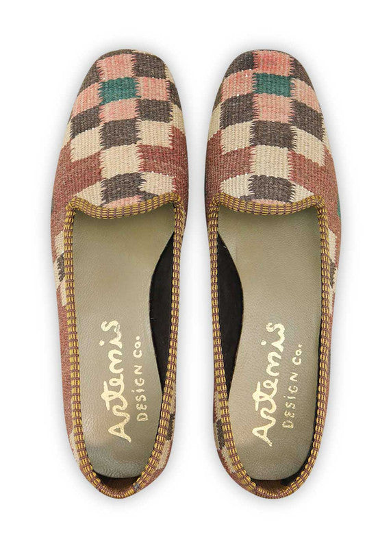 The Artemis Design & Co Women's Loafer is a stylish and versatile footwear choice with a chic color combination. Combining rich tones of brown, peach, and black, these loafers offer a harmonious and fashionable look. Crafted with attention to both style and comfort, they seamlessly complement a variety of outfits. (Front View)