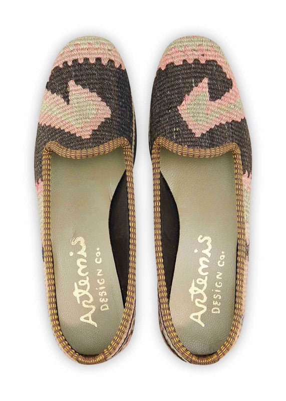 The Artemis Design & Co Women's Loafer is a chic and modern footwear choice featuring an elegant color palette. Combining shades of peach, black, grey, and purple, these loafers offer a sophisticated and tasteful look. Crafted with attention to both style and comfort, they seamlessly complement a variety of outfits. (Front View)