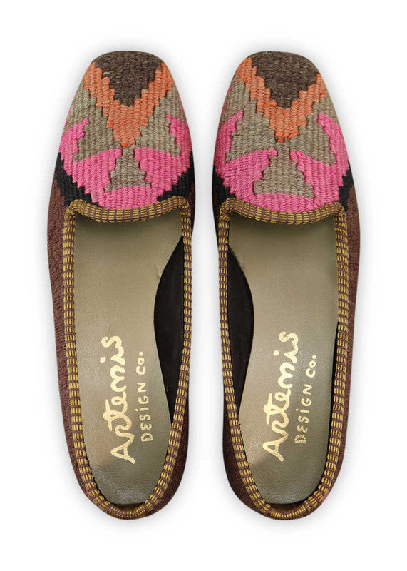 Artemis Design Co. Women's Loafers radiate chic and vibrant style with a captivating color combination of purple, black, fuchsia, grey, and orange. Meticulously crafted, these loafers seamlessly blend bold and lively tones, creating a versatile and eye-catching footwear option. The dynamic interplay of colors, from the deep purples and blacks to the playful fuchsia, subdued greys, and vibrant orange, adds a touch of modern flair.  (Front View)