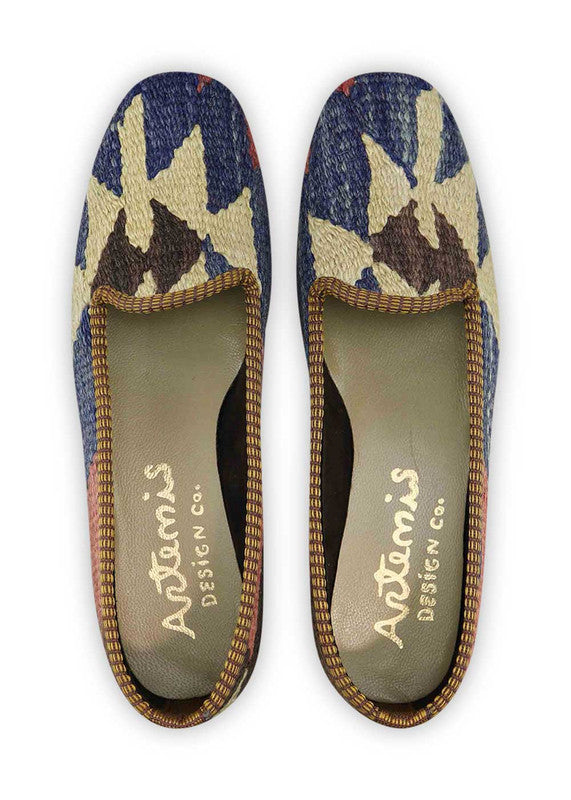 The Artemis Design & Co Women's Loafer is a stylish and versatile footwear choice characterized by a sophisticated color palette. Combining shades of blue, cream, maroon, black, and grey, these loafers offer a timeless and elegant look. (Front View)