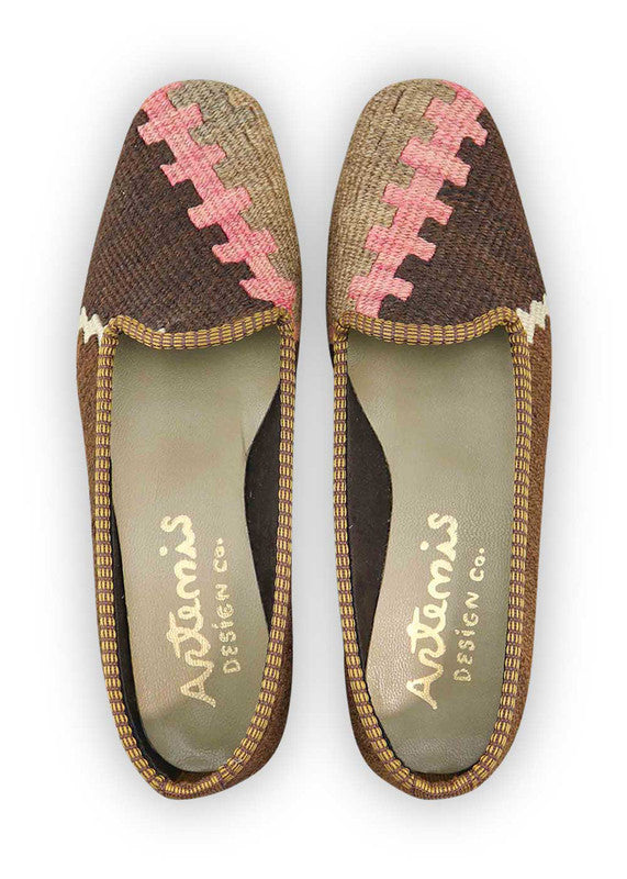 Artemis Design & Co Women's Loafers captivate with a warm and inviting color palette, featuring shades of brown, khaki, white, and delicate pink. These loafers seamlessly blend classic charm with a touch of femininity, creating a versatile footwear option for various occasions. (Front View)