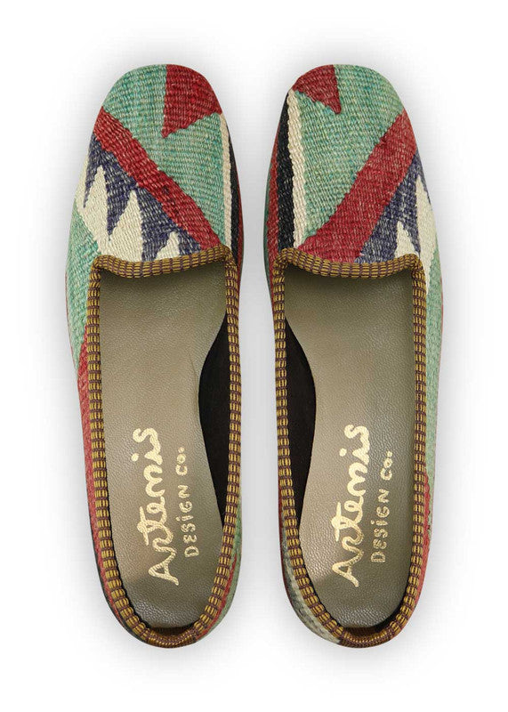Artemis Design Co. Women's Loafers make a bold statement with a classic color palette of black, red, white, grey, and green. Meticulously crafted, these loafers seamlessly blend timeless and vibrant tones, creating a versatile and stylish footwear option. The dynamic interplay of colors, from the classic black and white to the bold red and the subdued greys and greens, adds a touch of modern flair.  (Front View)