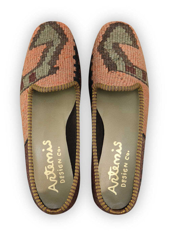 Artemis Design Co. Women's Loafers exude sophistication with a refined color palette of peach, black, brown, and grey. Meticulously crafted, these loafers seamlessly blend warm and neutral tones, creating a versatile and stylish footwear option. The dynamic interplay of colors, from the soft peach to the classic black and brown, complemented by the subtle grey, adds a touch of modern flair.  (Front View)