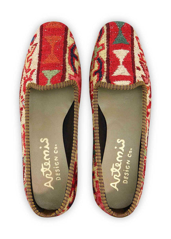 The Artemis Design & Co Women's Loafer is a stunning footwear choice that embraces a harmonious blend of colors. With a palette consisting of red, cream, white, maroon, blue, khaki, brown, and light green, these loafers offer a versatile and chic addition to your wardrobe. Meticulously crafted for both style and comfort, they seamlessly complement a wide range of outfits. (Front View)