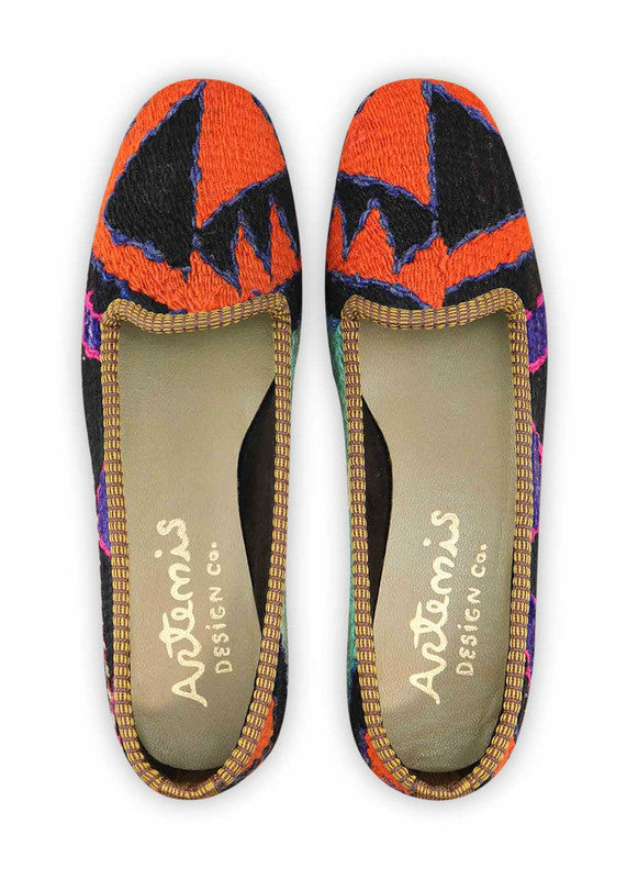 The Artemis Design & Co Women's Loafer is a striking and trendy footwear option featuring a captivating color combination. With hues of red-orange, black, purple, and mint green, these loafers make a bold and fashionable statement. Designed with attention to both style and comfort, they effortlessly elevate your outfit for various occasions. (Front View)