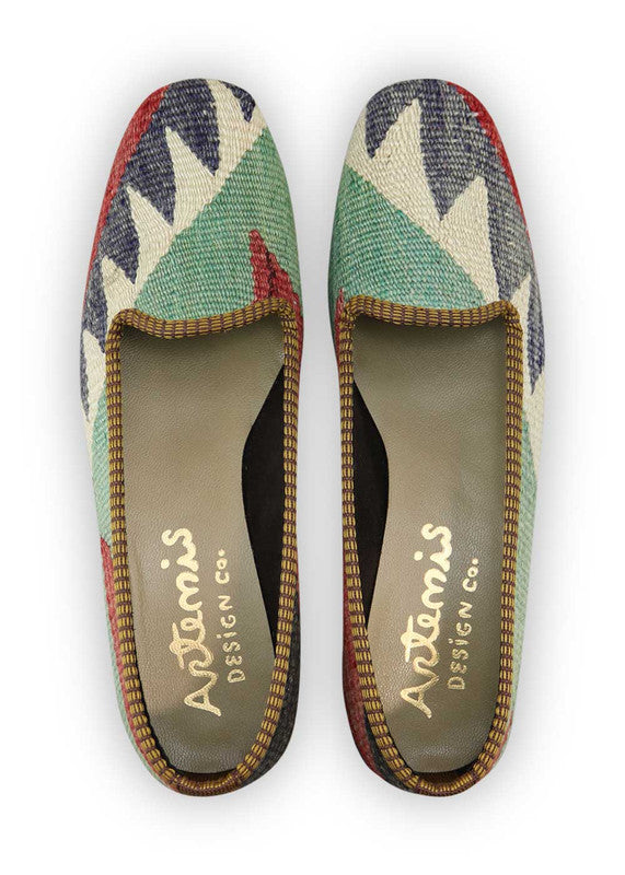 Artemis Design Co. Women's Loafers make a bold statement with a classic color palette of black, red, white, grey, and green. Meticulously crafted, these loafers seamlessly blend timeless and vibrant tones, creating a versatile and stylish footwear option. The dynamic interplay of colors, from the classic black and white to the bold red and the subdued greys and greens, adds a touch of modern flair. (Front View)