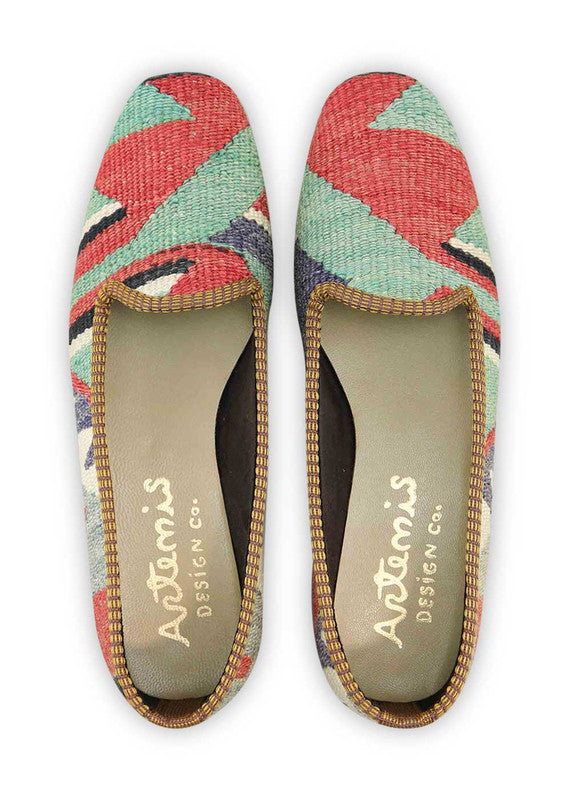 The Artemis Design & Co Women's Loafer is a fashionable and versatile footwear choice that embraces a vibrant color palette. With a combination of red, green, white, blue, black, and grey, these loafers offer a bold and stylish statement. Crafted for both aesthetics and comfort, they effortlessly complement a variety of outfits.  (Front View)