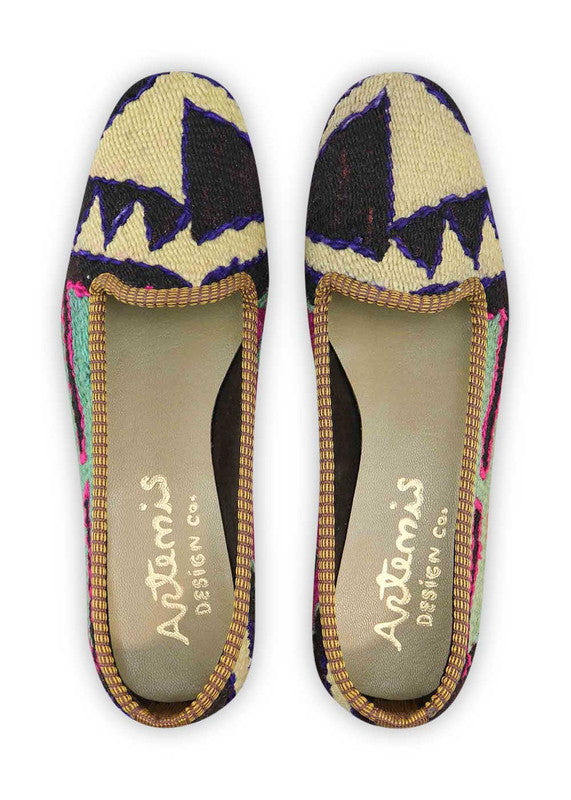 The Artemis Design & Co Women's Loafer is a truly vibrant and fashionable footwear choice. These loafers showcase an exquisite blend of colors, including black, navy blue, green, red orange, plum, sky blue, and cream. With such a rich and diverse color palette, they effortlessly elevate any outfit. (Front View)