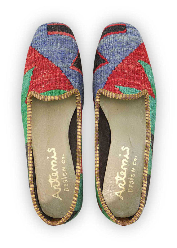 Artemis Design & Co Women's Loafers redefine classic elegance with a bold twist of color. Featuring a dynamic combination of black, red, blue, green, and yellow, these loafers are a vibrant expression of style. (Front View)