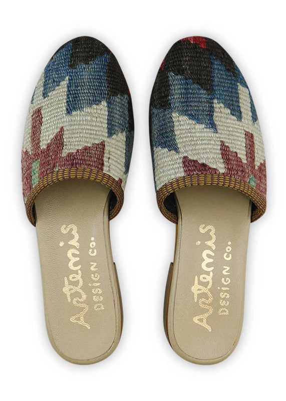 Artemis Design & Co's Women's Slides are the epitome of chic and fashionable footwear. With a stunning color combination of red, black, white, and blue, these slides are designed to turn heads. Crafted with meticulous attention to detail and using high-quality materials, they effortlessly add elegance to any outfit. (Front View)