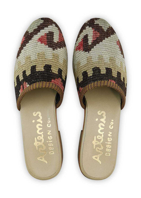 Artemis Design & Co's Women's Slides in brown, red, white, and khaki are the ultimate fashion statement. These stylish slides are meticulously designed with a stunning color combination that adds a touch of elegance to any outfit. Crafted with high-quality materials, they offer both comfort and durability. (Front View)