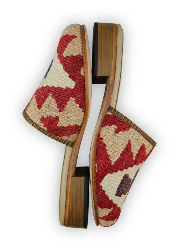 The Artemis Women's Slides offer a charming color combination of red, beige, white, and brown. These slides feature a delicate blend of warm and neutral tones, creating a balanced and versatile look. Whether you're lounging at home or stepping out for a casual occasion, these slides are the perfect choice. (Side View)