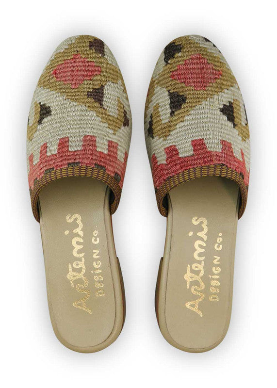 The Artemis Women's Slides feature a captivating color combination of brown, red, white, khaki, and black. These slides offer a striking blend of warm and neutral tones, creating a versatile and stylish look. Whether you're lounging at home or stepping out for a casual occasion, these slides are the perfect choice.  (Front View)