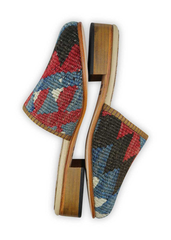 The Artemis Women's Slides offer a dynamic color combination of black, red, blue, and white. These slides feature a vibrant interplay of bold and classic tones, creating a modern and versatile look. Whether you're relaxing at home or heading out for a casual occasion, these slides are the perfect choice.(Side View)