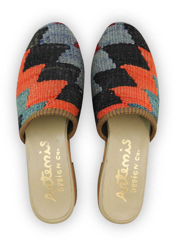 The Artemis Women's Slides exhibit a captivating color combination of red, blue, black, red orange, and dark grey. These slides offer a lively interplay of bold and classic tones, creating a dynamic and versatile look. Whether you're unwinding at home or stepping out for a casual outing, these slides are the perfect choice. (Front View)