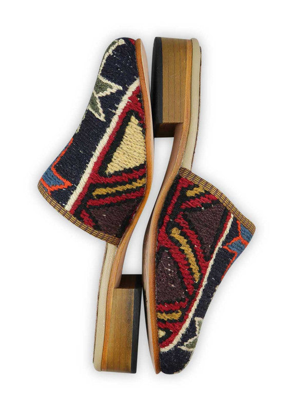 The Artemis Women's Slides showcase an energetic color combination that includes black, white, red, khaki, red orange, blue, mustard, and brown. These slides feature a dynamic interplay of classic and vibrant tones, creating a lively and fashionable look. (Side View)