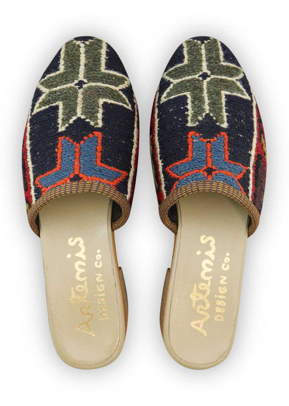 The Artemis Women's Slides showcase an energetic color combination that includes black, white, red, khaki, red orange, blue, mustard, and brown. These slides feature a dynamic interplay of classic and vibrant tones, creating a lively and fashionable look. (Front View)