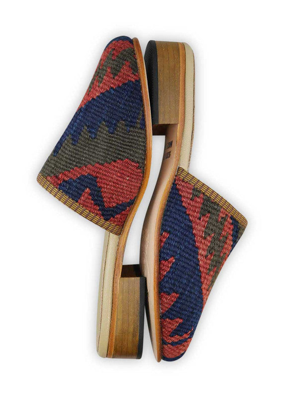 The Artemis Women's Slides exhibit a charming color combination of red, brown, and blue. These slides offer a tasteful blend of warm and cool tones, creating a versatile and stylish look. Whether you're enjoying a leisurely day or heading out for a casual outing, these slides are the perfect choice. (Side View)