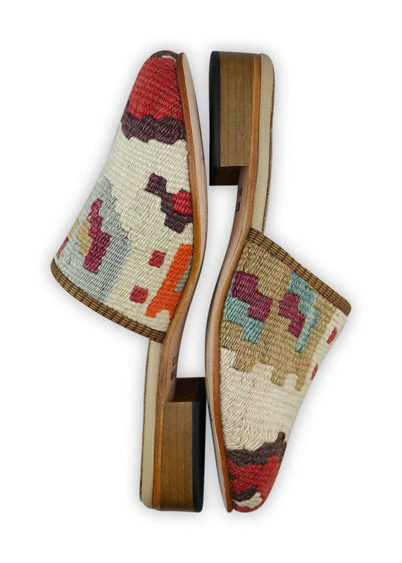 The Artemis Women's Slides showcase a lively color combination of red, brown, white, khaki, maroon, blue, and orange. These slides offer a vibrant mix of warm and neutral tones, creating a playful and eye-catching look. (Side View)