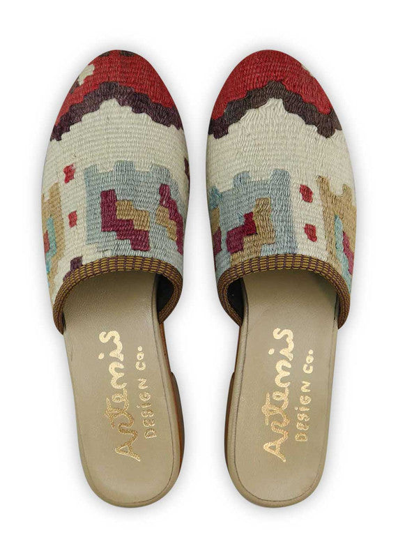 The Artemis Women's Slides showcase a lively color combination of red, brown, white, khaki, maroon, blue, and orange. These slides offer a vibrant mix of warm and neutral tones, creating a playful and eye-catching look. (Front View)