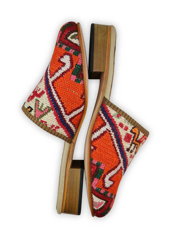 The Artemis Women's Slides feature a dynamic color combination of pink, red, white, black, orange, and moss green. These slides offer a vibrant mix of bold and energetic tones, creating a stylish and eye-catching look. Whether you're relaxing at home or stepping out for a casual outing, these slides are the perfect choice. (Side View)