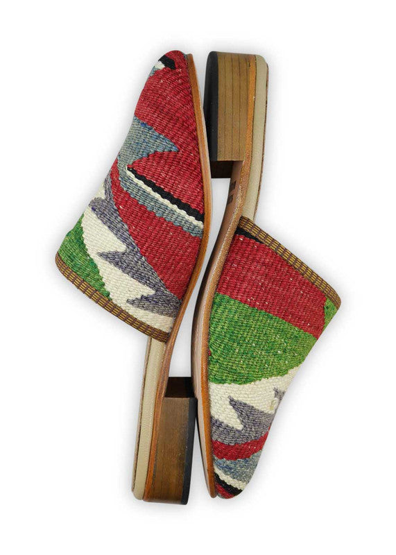 The Artemis Women's Slides feature a classic color combination of red, white, blue, green, and black. These slides offer a timeless blend of patriotic and versatile tones, creating a stylish and adaptable look. Whether you're lounging at home or stepping out for a casual outing, these slides are the perfect choice. (Side View)