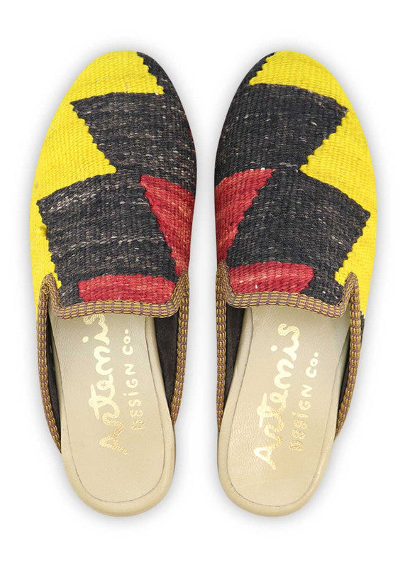 The Artemis Design& Co Women's Slippers in yellow, black, red, and green color combination are a stylish and comfortable choice for women. Made with high-quality materials and attention to detail, these slippers ensure durability and long-lasting comfort.  (Front View)