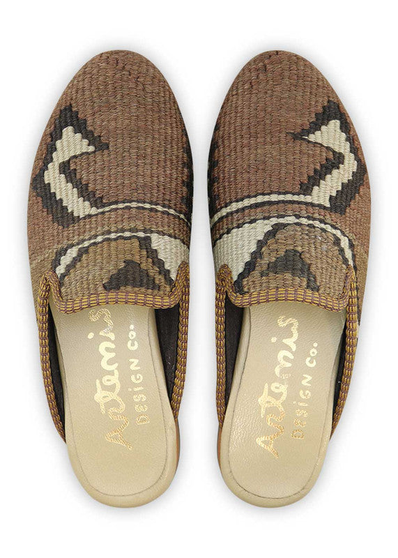 The Artemis Design& Co Women's Slippers are a stylish and comfortable choice for any woman. These slippers come in a classic color combination of brown, dark brown, and white. Crafted with high-quality materials and attention to detail, they offer durability and long-lasting comfort. (Front View)