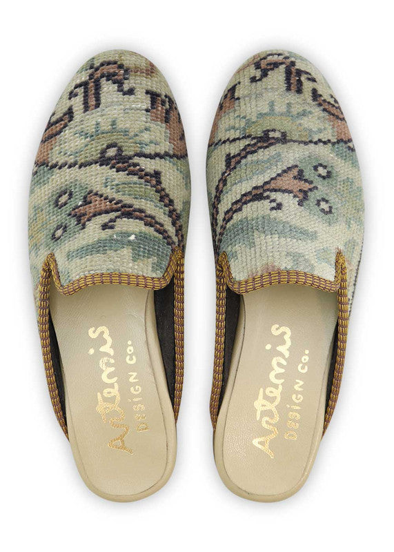 The Artemis Women's Slippers present a captivating blend of colors, featuring khaki, peach, black, green, and blue. These slippers seamlessly blend the natural charm of khaki with the softness of peach and the classic appeal of black, complemented by the vibrancy of green and the calming hues of blue.  (Front View)